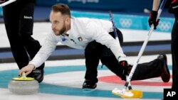 Italy's skip Joel Retornaz throws a stone during a men's curling match against Norway at the 2018 Winter Olympics in Gangneung, South Korea, Feb. 20, 2018.