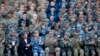 U.S. Army Pacific commander Gen. Robert Brown and Gen. Liu Xiaowu, the commander for Southern Theater Command Army of Chinese Liberation Army, applaud with their soldiers at a group photo session after conducting the U.S.-China Disaster Management Exchange (DME) drill at a PLA&#39;s training base in Kunming in southwest China&#39;s Yunnan province.