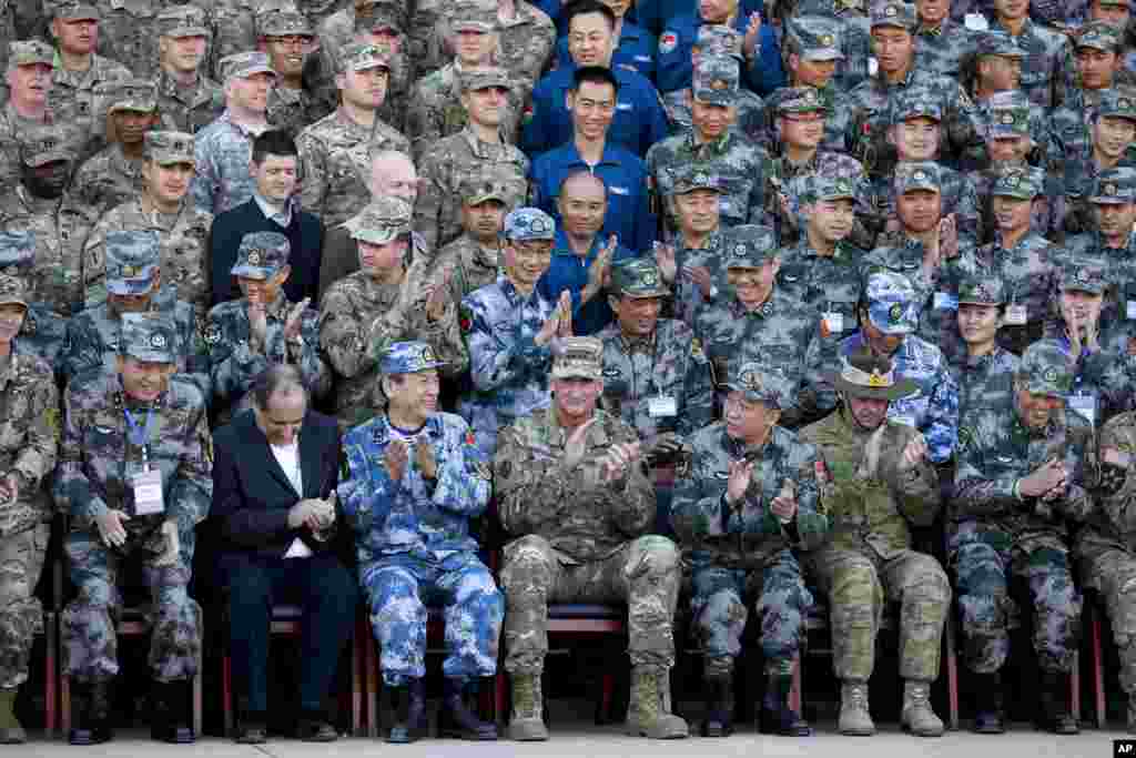 U.S. Army Pacific commander Gen. Robert Brown and Gen. Liu Xiaowu, the commander for Southern Theater Command Army of Chinese Liberation Army, applaud with their soldiers at a group photo session after conducting the U.S.-China Disaster Management Exchange (DME) drill at a PLA&#39;s training base in Kunming in southwest China&#39;s Yunnan province.