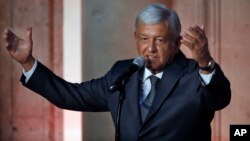 Mexico's President-elect Andres Manuel Lopez Obrador speaks to reporters after meeting with Mexico's President Enrique Pena Nieto at the National Palace in Mexico City, July 3, 2018.