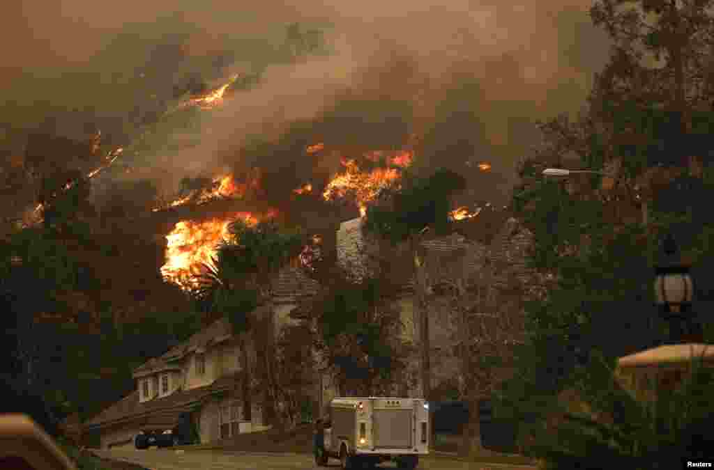 The Colby fire, which has so far scorched 125 acres, burns in the hills above Glendora, California.