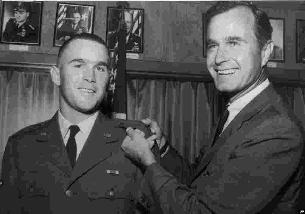 George W. Bush, left, is shown with his father, George H.W. Bush in this photo from 1968. 