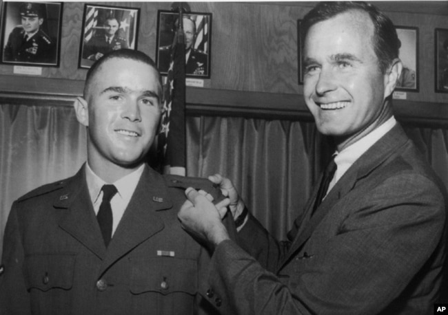 George W. Bush, left, is shown with his father, George H.W. Bush, in this photo from 1968.