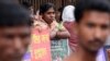 File - Bangladeshis participate in a rally marking International Literacy Day, in Dhaka, Bangladesh.