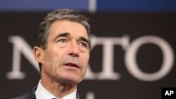 NATO Secretary General Anders Fogh Rasmussen addresses media, defense ministers meeting on Syria and Afghanistan, in Brussels, Feb. 21, 2013.