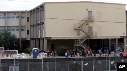 FILE - A temporary shelter for unaccompanied minors who have entered the country illegally is seen at Lackland Air Force Base, in San Antonio, June 23, 2014.