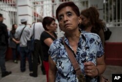 In this July 11, 2018 photo, Olga Hernandez, who recently lost her sight, stands outside of Mexico's President-elect Andres Manuel Lopez Obrador's headquarters in Mexico City. Hernandez is requesting a pension for seniors.