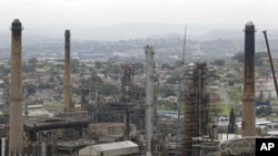 Chimneys from the Engen oil company are seen on the outskirts of the city of Durban, South Africa, the site of the COP17 climate talks, November 30, 2011.