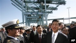 Chinese Vice President Xi Jinping , right, shakes hands with officers as he tours China Shipping at the Port Of Los Angeles in San Pedro, Calif. on Feb. 16, 2012.