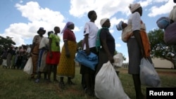 Zimbabwean villagers collect monthly food rations from Rutaura Primary School, Mt. Darwin, 254km north of Harare, March 7, 2013.