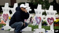 A person pauses in front of Stars of David with the names of those killed in a deadly shooting at the Tree of Life Synagogue, in Pittsburgh, Monday, Oct. 29, 2018. (AP Photo/Matt Rourke)