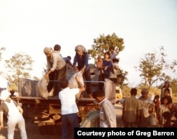 Food is unloaded in a refugee camp in Thailand in November 1979. (Photo courtesy of Greg Barron)