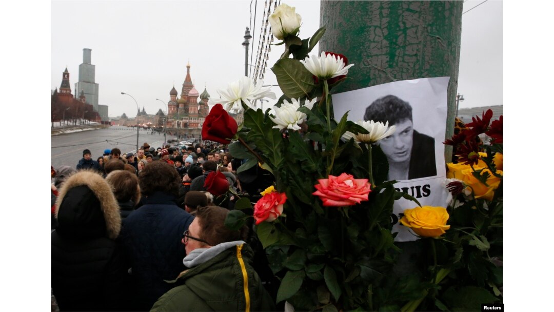 People gather at the site where Boris Nemtsov was recently murdered, with St. Basil's Cathedral and the Kremlin seen in the background, in central Moscow, Feb. 28, 2015.