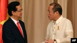 Philippine President Benigno Aquino III, right, shakes hands with Vietnamese Prime Minister Nguyen Tan Dung after their joint press statement at the Malacanang Presidential Palace in Manila, Philippines, May 21, 2014. 