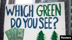 A protester carries a sign during the "People's Climate March" in the Manhattan borough of New York September 21, 2014.