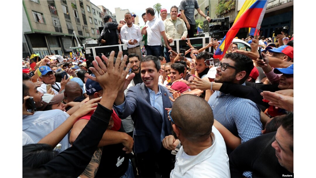 Venezuelan opposition leader Juan Guaido, whom many nations have recognized as the country's rightful interim ruler, greets supporters during a rally in Los Teques, Venezuela, March 30, 2019.