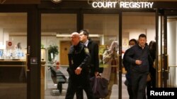 People are escorted out of the court registry by a B.C. sheriff after the B.C. Supreme Court bail hearing of Huawei CFO Meng Wanzhou, who was released on a $10 million bail in Vancouver, British Columbia, Canada, Dec. 11, 2018.