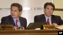 FILE - Tamaulipas Governor Tomas Yarrington, left, and Texas Governor Rick Perry are seen at the end of the XXIth Border Governors Conference in Chihuahua, Mexico, Aug. 8, 2003. 