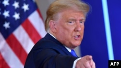 US President Donald Trump gestures after speaking during election night in the East Room of the White House in Washington. 