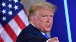 US President Donald Trump gestures after speaking during election night in the East Room of the White House in Washington.