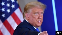 FILE - U.S. President Donald Trump gestures after speaking on election night, Nov. 3, 2020, in the East Room of the White House in Washington.