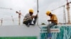 FILE - Workers work at the Vietnam Hoang Anh Gia Lai (HAGL) construction site in Rangoon, Sept. 20, 2013.