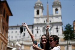 Two women take a selfie at the Spanish Steps in Rome, June 28, 2021.