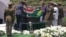 In this video frame grab, military officers remove a South African flag from Nelson Mandela's casket at his burial site in Qunu, South Africa, Sunday, Dec. 15, 2013.