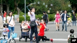 Taiwanese people enjoy their weekend, Nov. 20, 2016, at the Sun Yat-sen Memorial Hall in Taipei, Taiwan. Taiwan will soon start mandating two-day weekends for its workforce. The changed labor standards reflect desires for better work-life balance in this affluent, industrialized island.