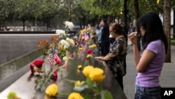 Les membres de la famille au mémorial du 11 septembre lors de la cérémonie de commémoration du 22e anniversaire des attentats terroristes du 11 septembre 2001, le 11 septembre 2023, à New York.