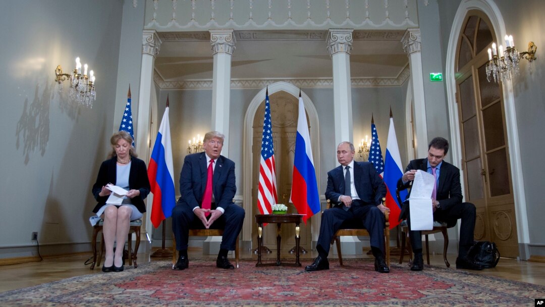 Russian President Vladimir Putin and U.S. President Donald Trump, with their interpreters at the beginning of their meeting at the Presidential Palace in Helsinki, Finland, July 16, 2018.