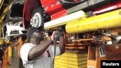FILE - An assembly worker works on 2015 Ford Mustang vehicles on the production line at the Ford Motor Flat Rock Assembly Plant in Flat Rock, Michigan, Aug. 20, 2015. 