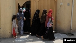 Afghan women leave after they attended classes at the Skills Academy for Needy Aspirants in Peshawar, Pakistan, Aug. 9, 2023