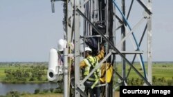 Workers for Alphabet's Taara project install receiving equipment for light beams that carry high-speed data signals through the air. (Photo Credit/Alphabet/X)