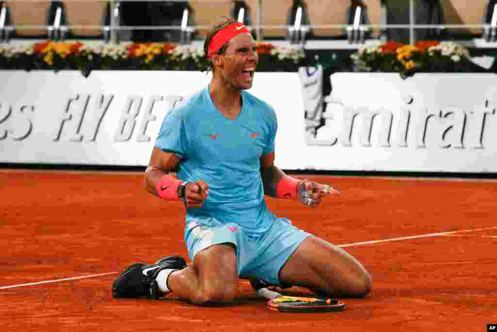Spain&#39;s Rafael Nadal celebrates winning the final match of the French Open tennis tournament against Serbia&#39;s Novak Djokovic in three sets, 6-0, 6-2, 7-5, at the Roland Garros stadium in Paris, France.