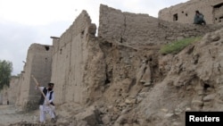 Man clears rubble after part of his house collapsed during an earthquake, Jalalabad, Afghanistan, Oct. 26, 2015.