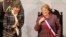 FILE - Chile's President Michelle Bachelet smiles next to Senate President Isabel Allende (L), daughter of late former President Salvador Allende, after delivering her annual address at the national congress building in Valparaiso city, northwest of Santiago, May 21, 2014.