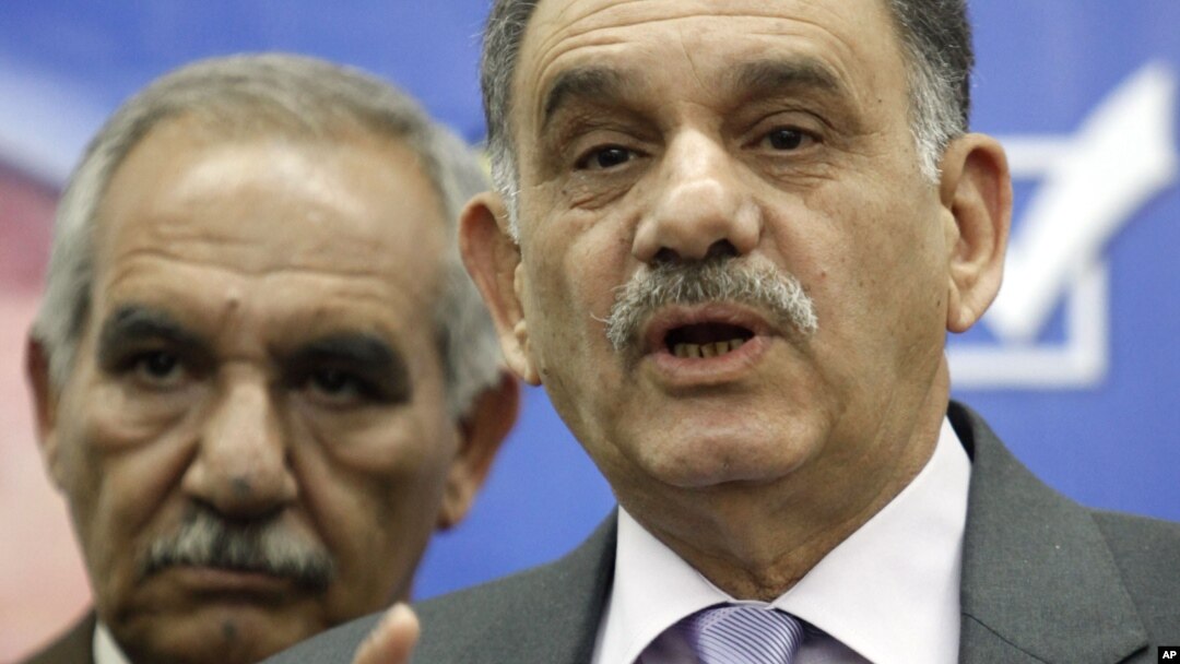 In this February. 25, 2010 file photo, Iraq’s Deputy Prime Minister Saleh al-Mutlaq, right, speaks to reporters in Baghdad, Iraq. 