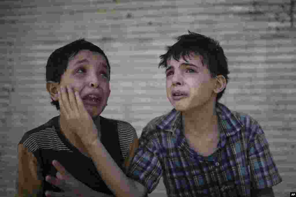 Zeid Ali, 12, left, and Hodayfa Ali, 11, comfort each other after their house was hit and collapsed during fighting between Iraqi forces and Islamic State militants in Mosul, Iraq, June 24, 2017. The Ali cousins said some of their family members were still under the rubble.