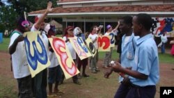 Justin Silbaugh (second from left in cap) and staffers welcome arriving students to art camp in Uganda.