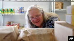 Rose Carney is shown organizing supplies at the food pantry at Harvest Christian Fellowship Church in Eagle River, Alaska, on April 17, 2023.