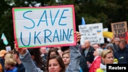 Protesters in Berlin protest militarization, delivery of weapons to Ukraine, Israel or other countries, and stationing U.S medium-range weapons in Germany. They also back peace negotiations between Russia and Ukraine, and Israel and Hamas, Oct. 3, 2024.