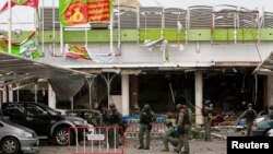 Military personnel inspect the site of a bomb attack at a supermarket in Pattani, Thailand, May 10, 2017. 