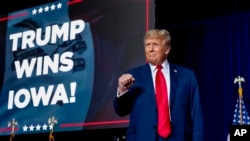 Republican presidential candidate former President Donald Trump takes the stage at a caucus night party in Des Moines, Iowa, Jan. 15, 2024. 