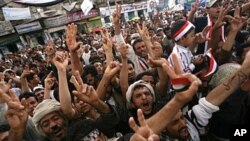 Yemeni anti-government protesters shout slogans during a demonstration demanding the resignation of President Ali Abdullah Saleh in Sana'a, April 28, 2011