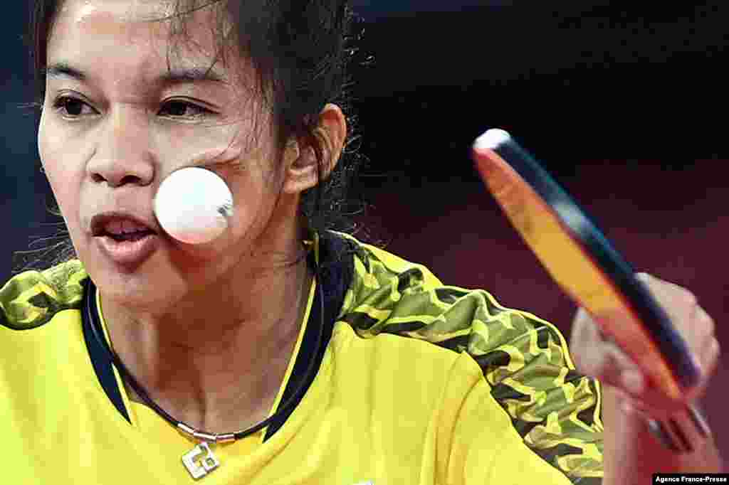 The ball hits Thailand's Orawan Paranang's face as she competes against Japan's Kasumi Ishikawa during the women's singles round 3 table tennis match at the Tokyo Metropolitan Gymnasium during the Tokyo 2020 Olympic Games in Tokyo, July 26, 2021.