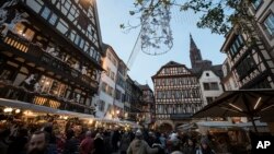 People are once again in the streets as Strasbourg's Christmas market reopens under the protection of police, in Strasbourg, France, Dec. 15, 2018.