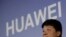 Huawei Rotating Chairman Guo Ping, center, speaks during a press conference in Shenzhen city, China's Guangdong province, Thursday, March 7, 2019. Chinese tech giant Huawei is launching a U.S. court challenge to a law that labels the company a security risk 