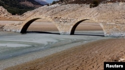 FILE - The dried, cracked bed of the Qaraoun artificial lake is seen in West Bekaa, Lebanon, Sept. 19, 2014.