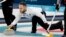 Italy's skip Joel Retornaz throws a stone during a men's curling match against Norway at the 2018 Winter Olympics in Gangneung, South Korea, Feb. 20, 2018.